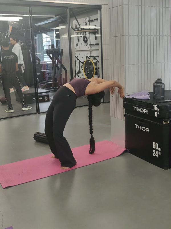 Student practising Standing backbend at the wall